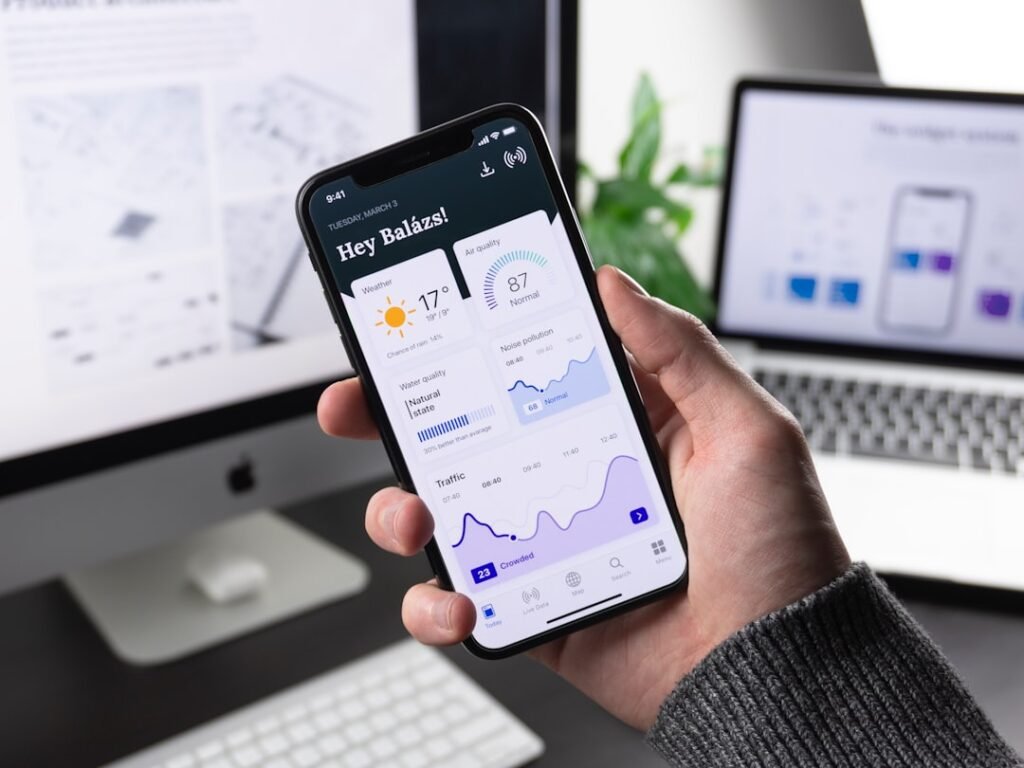 Person holding smartphone showing a productivity and data dashboard app