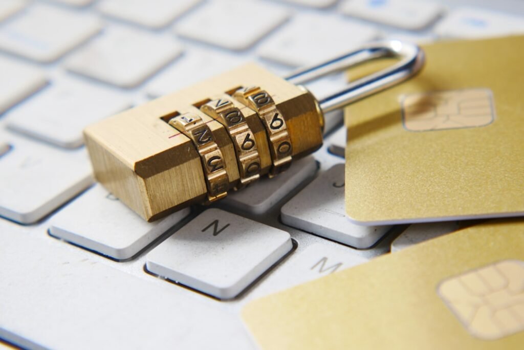 Combination padlock resting on a keyboard next to credit cards, representing digital security and data privacy